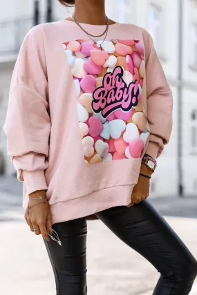 Maglia felpa oversize rosa in cotone con stampa caramelle multicolore e bordi polsini elasticizzati